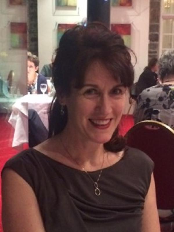 Val, IH Bristol's director, sat at a gala dinner.